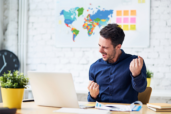 Man successful happy at the computer