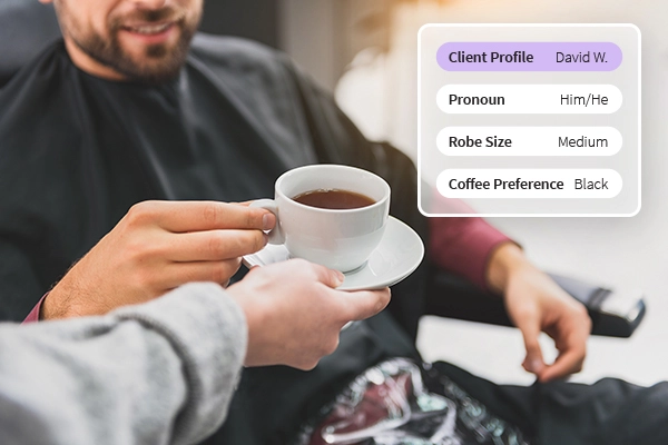 Service provider giving a male client coffee at a salon