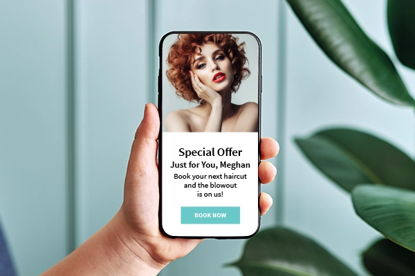 cell phone showing a special offer email to book now for salon appointment